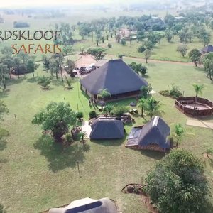 Lodge area with surrounding chalets, boma and swimming pool.