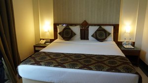 JP Cordial in Bengaluru, image may contain: Bed, Furniture, Bedroom, Indoors