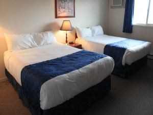 Fairway Inn in Sussex, image may contain: Bed, Furniture, Bedroom, Indoors