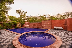 Mandore Guest House - a leafy resort. in Jodhpur, image may contain: Pool, Villa, Hotel, Resort