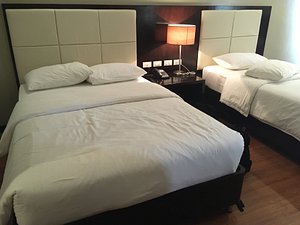 Ever O Business Hotel in Mindanao, image may contain: Furniture, Bed, Lamp, Table Lamp