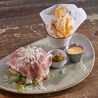 Parma burger with 150gr of rib eye meat, Brioche bun, prosciutto, brass tomato relish, rucola