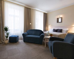 Unitas Hotel in Prague, image may contain: Couch, Furniture, Plant, Living Room