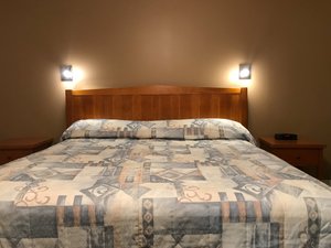 Alpine Motor Inn in Alma, image may contain: Furniture, Bed, Bedroom, Indoors