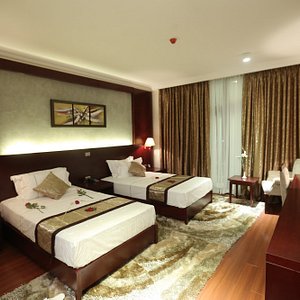 Sidra International Hotel in Addis Ababa, image may contain: Home Decor, Table Lamp, Lamp, Bed