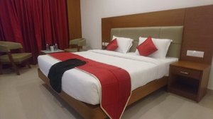 Park Residency in Kozhikode, image may contain: Bed, Furniture, Chair, Bedroom