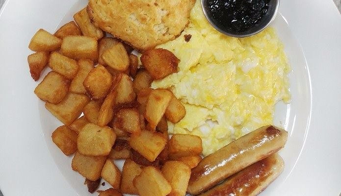 The Classic with scrambled eggs sausage and blueberry jam