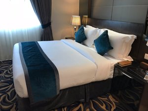Omega Hotel in Dubai, image may contain: Furniture, Bed, Cushion, Bedroom