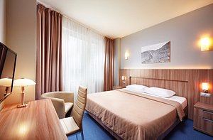 Slavyanskaya Hotel in Minsk, image may contain: Furniture, Lamp, Bedroom, Bed