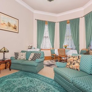 Guest lounge with dining table, television, fridge, tea and coffee facilities.