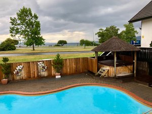Le Chalet Suisse Motel in Taupo, image may contain: Backyard, Outdoors, Plant, Hot Tub