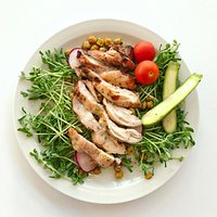 honey garlic boneless chicken thighs on a bed of sweet pea sprouts, + radish