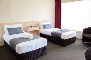 Beachway Motel & Restaurant in Ulverstone, image may contain: Furniture, Bed, Dorm Room, Bedroom