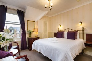 Lincoln House Private Hotel in Cardiff, image may contain: Bed, Furniture, Home Decor, Bedroom