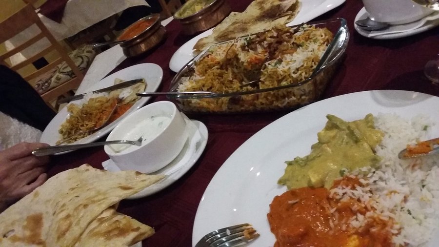 A spread of naan, raita, biryani, and much more