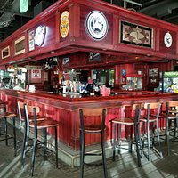 Stone accented walls, a cherry hued bar, and intimate lighting welcome you.