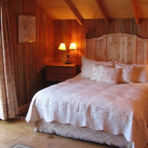 One of three bedrooms en-suite finished in native wood paneling.
