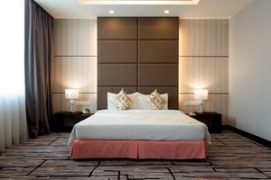 Promenade Hotel Bintulu in Bintulu, image may contain: Interior Design, Furniture, Home Decor, Bed