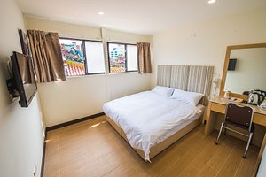 Longshan Inn in Wanhua, image may contain: Dorm Room, Furniture, Bed, Chair