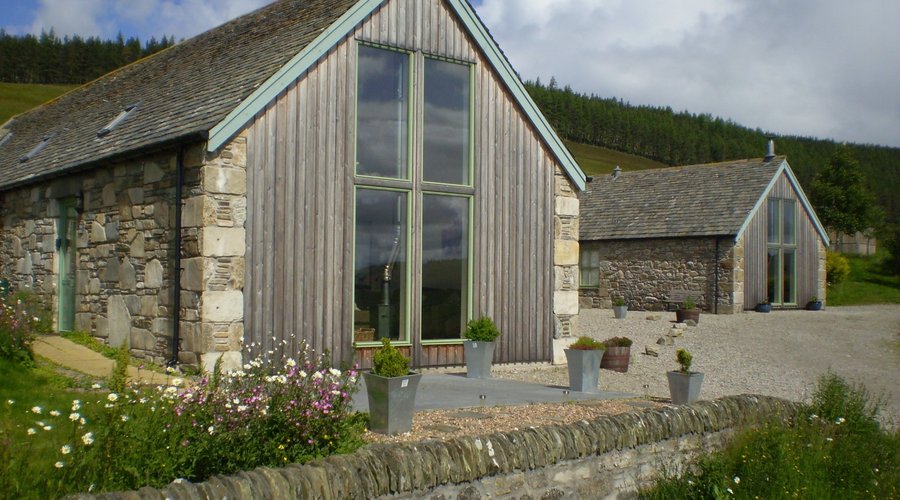 The Mill and The Grain Store cottages looking out across the eastern Cairngorms National Park