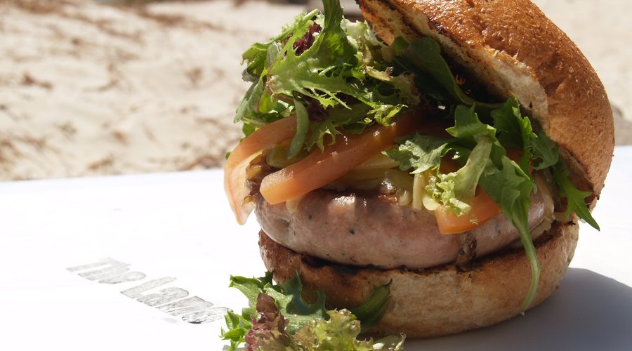 Reservoir Dog - Pork sausage, jalapeno harissa, lettuce, tomato, cheese and mayo on a toasted bu
