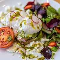 Poached eggs, smashed avocado, feta, pesto on sourdough toast