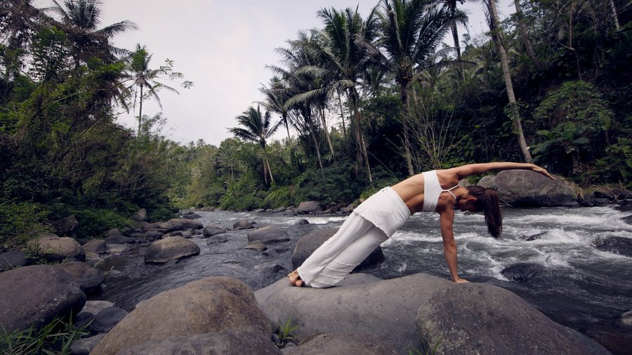 Side bend pose next to Ayung River in Ubud