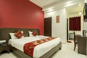 Hotel Metropolitan in Jaipur, image may contain: Bed, Furniture, Chair, Bedroom