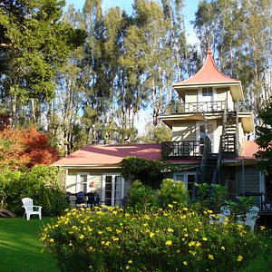 The historic, river side lodge with mature gardens and sweeping pagoda roof