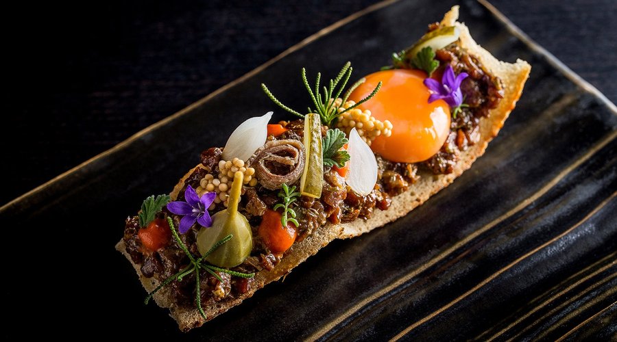 Beef tartare French style with confit egg, marinated mustard seed, caper