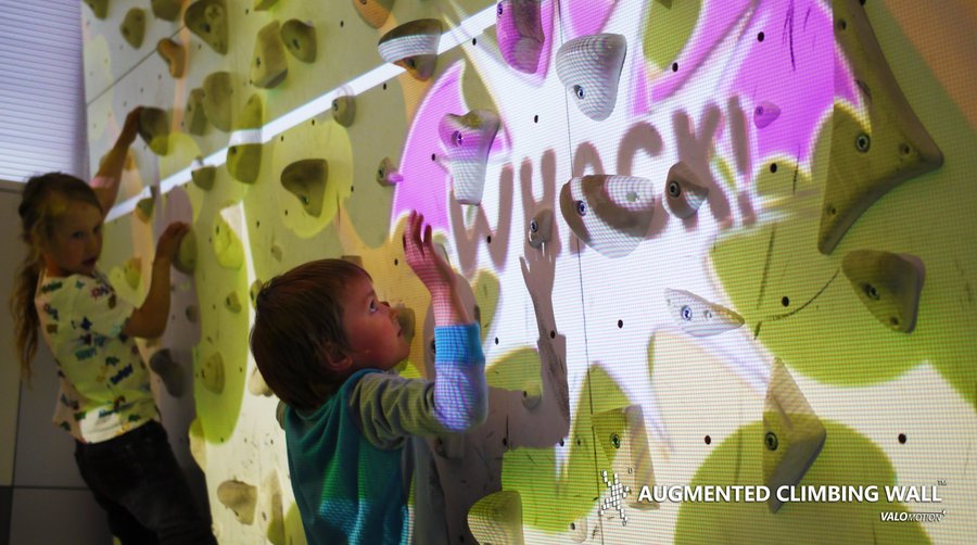 Another picture of climbers trying just one of over 100 games on our new ACE wall.