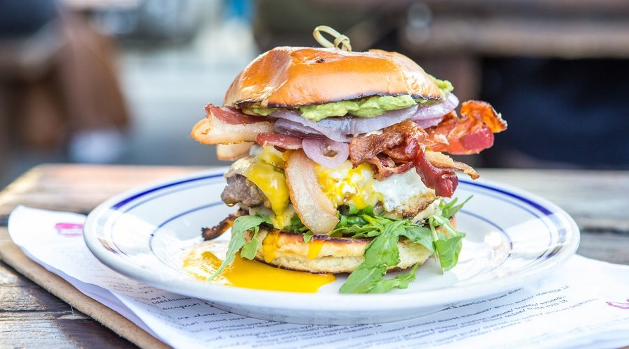 The Proper Burger, fully loaded with bacon, avocado and runny egg.