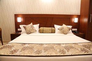 Hotel Varanasi Inn in Varanasi, image may contain: Cushion, Home Decor, Furniture, Bed