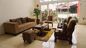 The Garden Hotel in Gorontalo, image may contain: Living Room, Furniture, Home Decor, Couch