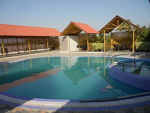 The Divine Resort in Dari, image may contain: Hotel, Resort, Villa, Pool