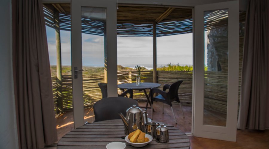 Outside patio at Oppiduin accommodation. Enjoy your morning cup of coffee overlooking the ocean from your private little patio. 