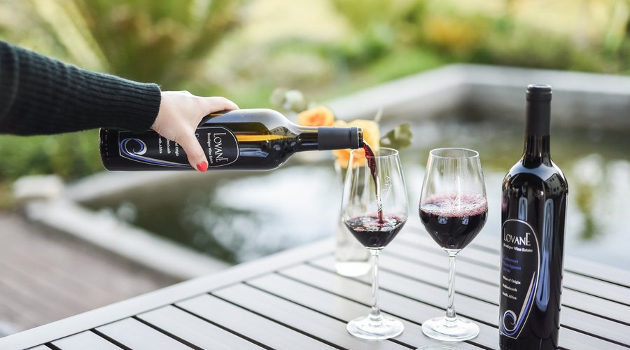 Enjoy some wine by the fish pond.