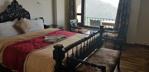 Birds View Kasauli in Kasauli, image may contain: Furniture, Bed, Bedroom, Room