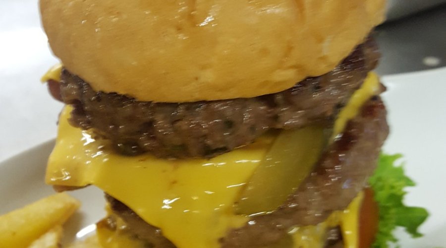 Monster burger of 3 x 150g burger patties of beef, lamb and pork topped with cheese and bacon