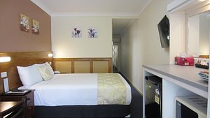 Taree Highway Motor Inn in Taree, image may contain: Furniture, Bedroom, Bed, Indoors