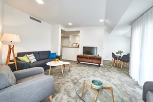 Perla Residence Hotel & SPA in Podgorica, image may contain: Living Room, Couch, Screen, Monitor