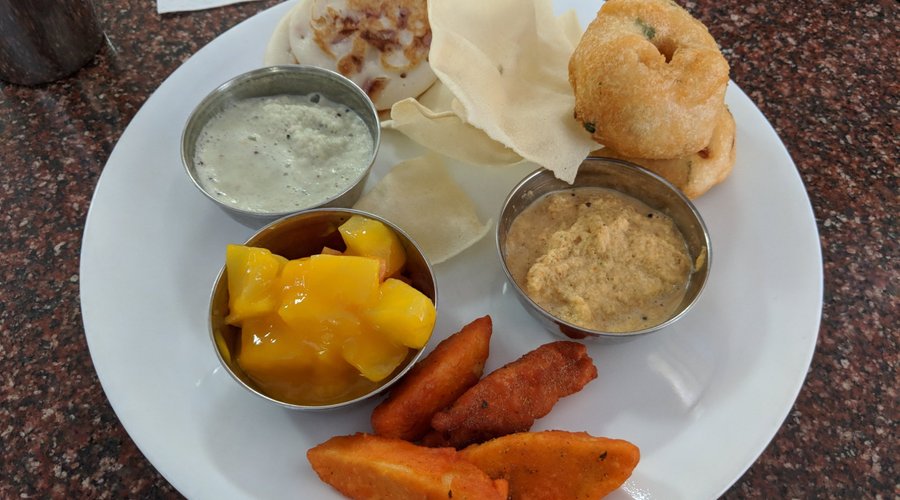 Set Uttapam, Papad, Vada, Chutney, Idli 65, Fruit Custard, Coconut Chutney