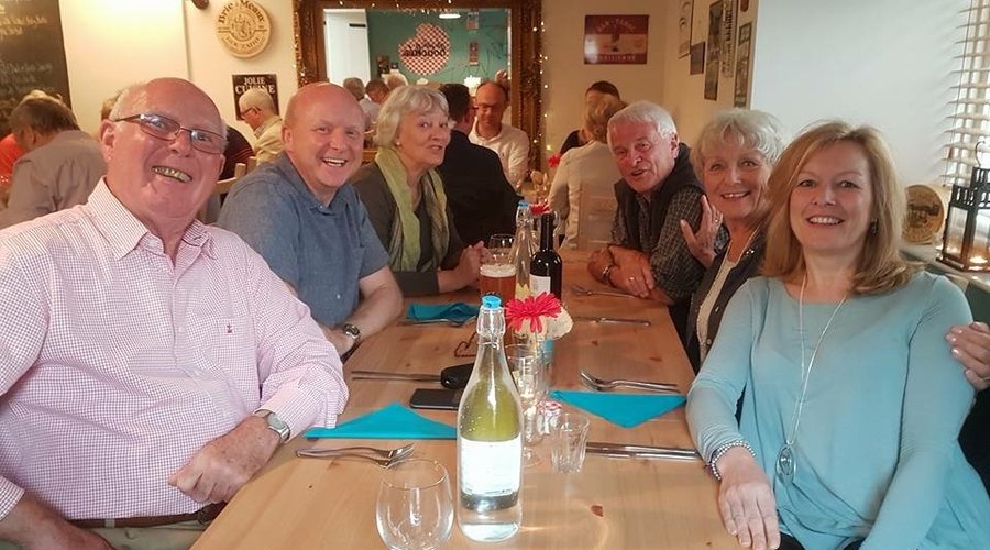 Full restaurant with two parties celebrating birthdays 