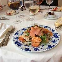 A duo of cooked and smoked salmon served on a fresh salad, dressed with capers and home made dre