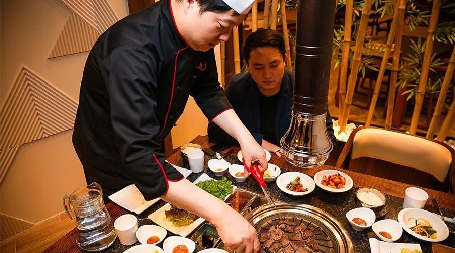 Chef Kim serving guests.