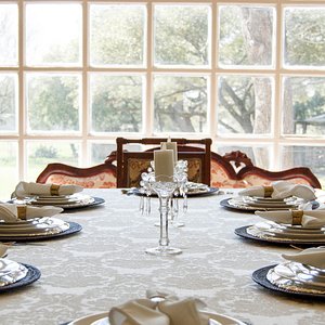 Grand dining room with crystal chandelier overlooking the great lawn