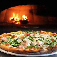 Freshly prepared pizzas and locally sourced produce, all cooked in a wood-fired oven