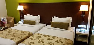 Ramee Grand Hotel Pune in Pune, image may contain: Furniture, Bedroom, Bed, Indoors