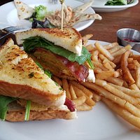 Fried green tomato club sandwich with tomato jam. In the background is the smoked tuna dip.