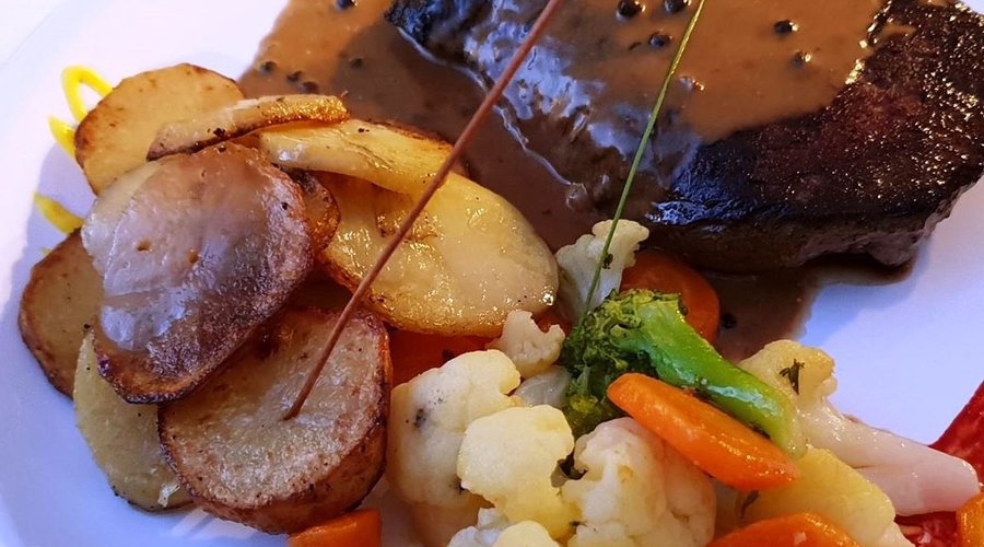 Pepper Steak with roasted potatoes and steamed vegetables